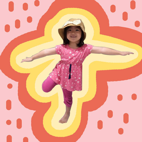 little girl with hat doing yoga poses