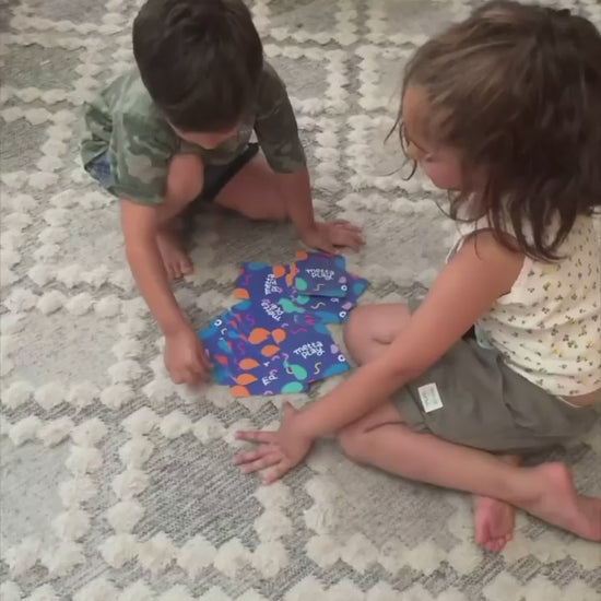 Siblings playing with yoga cards